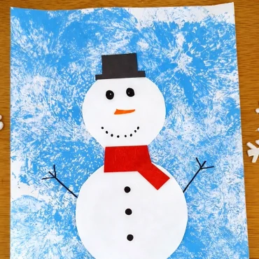 Auf den Hintergrund einen Schneemann malen oder aus Papier basteln