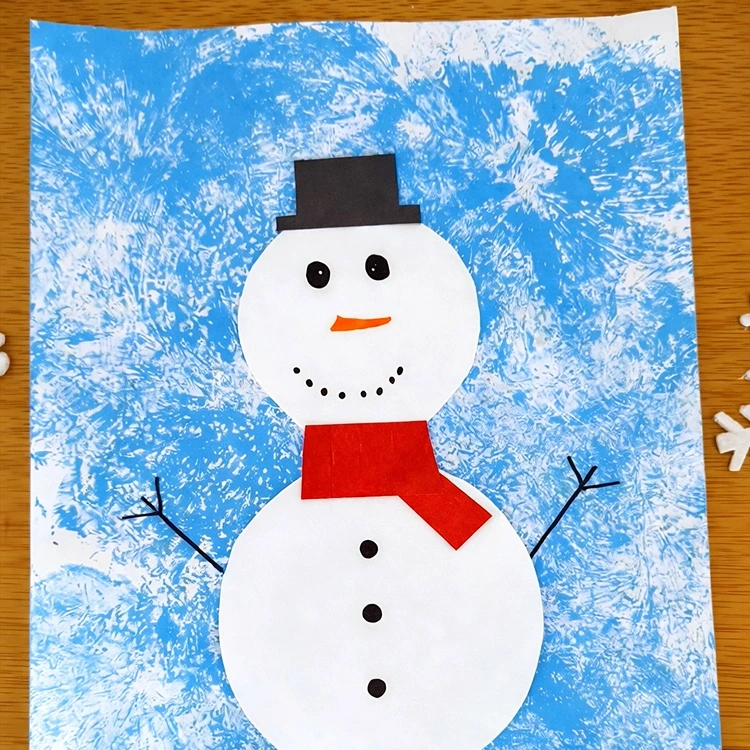 Auf den Hintergrund einen Schneemann malen oder aus Papier basteln
