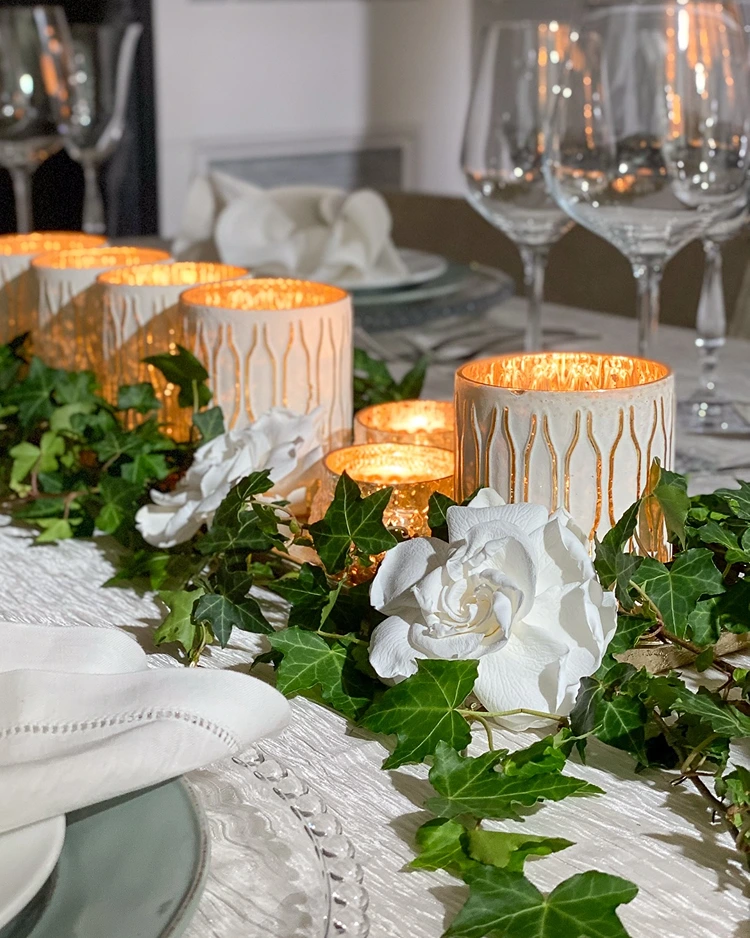 Rechteckigen Esstisch mit weißen Rosen, Windlichtern und Efeublättern gestalten